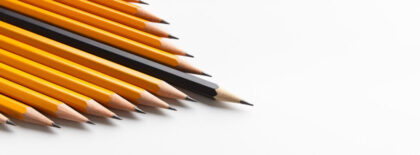 Group of yellow classic pencils following black one